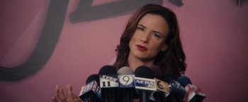 Movie still from “Jem and the Holograms” (2015), directed by Jon M. Chu – A woman is standing in front of microphones; Close Up shot, Over the shoulder angle