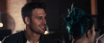 Movie still from “Jem and the Holograms” (2015), directed by Jon M. Chu – A person with a blue wig; Close Up shot, Over the shoulder angle