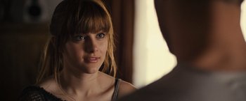 Movie still from “Jem and the Holograms” (2015), directed by Jon M. Chu – A woman looking into a mirror while standing next to a man; Close Up shot, Over the shoulder angle