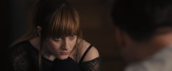 Movie still from “Jem and the Holograms” (2015), directed by Jon M. Chu – A young woman in a black dress looking at the camera; Close Up shot, Over the shoulder angle