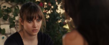 Movie still from “Jem and the Holograms” (2015), directed by Jon M. Chu – A woman with bangs is looking at another woman; Close Up shot, Over the shoulder angle