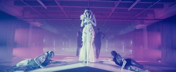 Movie still from “Jem and the Holograms” (2015), directed by Jon M. Chu – A woman standing on a stage in front of other people; Wide shot, Low angle