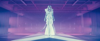 Movie still from “Jem and the Holograms” (2015), directed by Jon M. Chu – A woman in a white dress standing on a platform; Wide shot, Low angle
