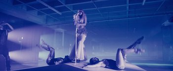 Movie still from “Jem and the Holograms” (2015), directed by Jon M. Chu – A woman standing on a stage holding a microphone; Wide shot, Low angle