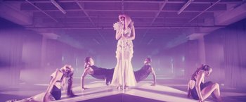 Movie still from “Jem and the Holograms” (2015), directed by Jon M. Chu – A woman standing on top of a pole in front of two men; Wide shot, Overhead angle