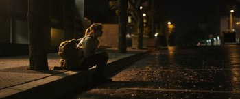 Movie still from “Jem and the Holograms” (2015), directed by Jon M. Chu – A woman sitting on the side of the street at night; Wide shot, High angle