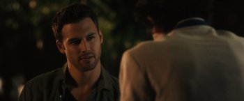 Movie still from “Jem and the Holograms” (2015), directed by Jon M. Chu – A man standing next to another man in front of a tree; Close Up shot, Over the shoulder angle