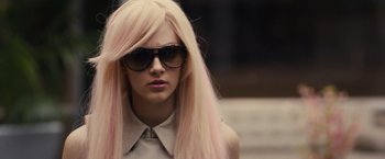 Movie still from “Jem and the Holograms” (2015), directed by Jon M. Chu – A woman with long pink hair wearing sunglasses; Close Up shot, Over the shoulder angle