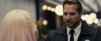 Movie still from “Jem and the Holograms” (2015), directed by Jon M. Chu – A person wearing a suit and tie; Close Up shot, Over the shoulder angle