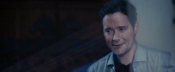 Movie still from “Jem and the Holograms” (2015), directed by Jon M. Chu – A person wearing a button up shirt; Close Up shot, Over the shoulder angle