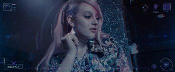 Movie still from “Jem and the Holograms” (2015), directed by Jon M. Chu – A woman with pink hair is posing for a picture; Close Up shot, High angle