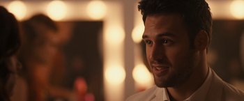 Movie still from “Jem and the Holograms” (2015), directed by Jon M. Chu – A man's face in front of lights; Close Up shot, Over the shoulder angle