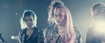 Movie still from “Jem and the Holograms” (2015), directed by Jon M. Chu – A group of young people standing next to each other; Close Up shot, Over the shoulder angle