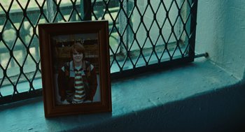 Movie still from “Jennifer's Body” (2009), directed by Karyn Kusama – A picture of a young boy in a frame; Close Up shot, High angle