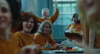 Movie still from “Jennifer's Body” (2009), directed by Karyn Kusama – A group of people sitting at a table with plates of food on it; Medium shot, Over the shoulder angle