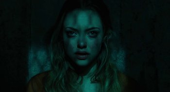 Movie still from “Jennifer's Body” (2009), directed by Karyn Kusama – A woman with long blonde hair is in the dark; Close Up shot, High angle