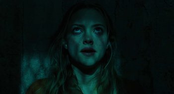 Movie still from “Jennifer's Body” (2009), directed by Karyn Kusama – A woman stares into the camera with a dark background; Close Up shot, Low angle
