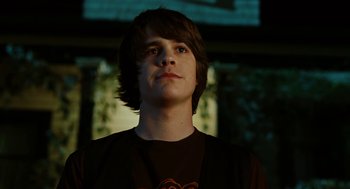 Movie still from “Jennifer's Body” (2009), directed by Karyn Kusama – A young man is standing in front of a television; Close Up shot, Low angle