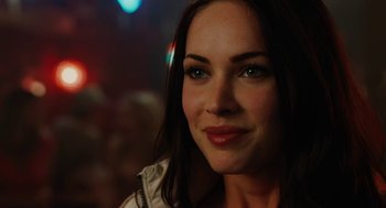 Movie still from “Jennifer's Body” (2009), directed by Karyn Kusama – A woman's face at a party; Close Up shot, Over the shoulder angle