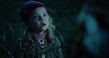 Movie still from “Jennifer's Body” (2009), directed by Karyn Kusama – A little girl wearing a sweater and a hat looking up; Close Up shot, Low angle