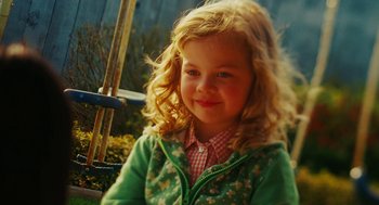 Movie still from “Jennifer's Body” (2009), directed by Karyn Kusama – A little girl sitting on top of a wooden swing set; Close Up shot, Over the shoulder angle