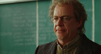 Movie still from “Jennifer's Body” (2009), directed by Karyn Kusama – An older man wearing glasses and a jacket; Close Up shot, Over the shoulder angle