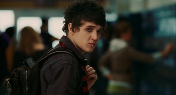 Movie still from “Jennifer's Body” (2009), directed by Karyn Kusama – A young man with black hair wearing a tie; Close Up shot, Over the shoulder angle