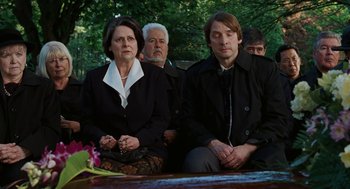 Movie still from “Jennifer's Body” (2009), directed by Karyn Kusama – A group of people sitting on a wooden bench; Medium shot, High angle