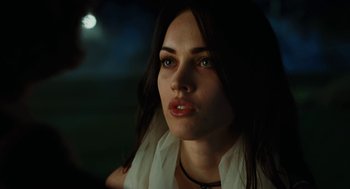 Movie still from “Jennifer's Body” (2009), directed by Karyn Kusama – A beautiful woman with long dark brown hair and green eyes; Close Up shot, Over the shoulder angle