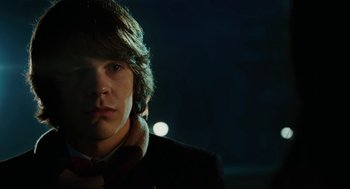 Movie still from “Jennifer's Body” (2009), directed by Karyn Kusama – A young man in a black jacket is looking at the camera; Close Up shot, Over the shoulder angle