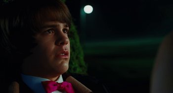 Movie still from “Jennifer's Body” (2009), directed by Karyn Kusama – A young man wearing a pink bow tie; Close Up shot, Low angle