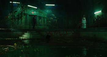 Movie still from “Jennifer's Body” (2009), directed by Karyn Kusama – A man standing in a room with graffiti on the wall; Extreme Wide shot, High angle
