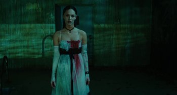Movie still from “Jennifer's Body” (2009), directed by Karyn Kusama – A woman in a white dress with blood on her dress; Medium shot, Low angle