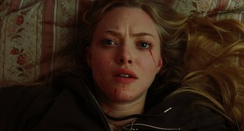 Movie still from “Jennifer's Body” (2009), directed by Karyn Kusama – A person laying on the ground with blood all over her face; Close Up shot, Overhead angle