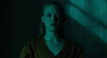 Movie still from “Jennifer's Body” (2009), directed by Karyn Kusama – A woman in a yellow shirt is in a dark room; Close Up shot, Low angle