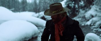 Movie still from “Jeremiah Johnson” (1972), directed by Sydney Pollack – A man with a hat and a scarf in the snow; Medium shot, Low angle