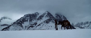 Movie still from “Jeremiah Johnson” (1972), directed by Sydney Pollack – Two people are walking in the snow with a horse; Extreme Wide shot, Low angle