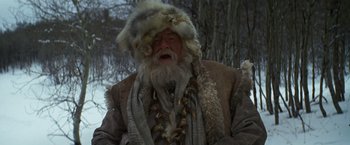 Movie still from “Jeremiah Johnson” (1972), directed by Sydney Pollack – An old man with a beard and a fur hat; Medium shot, Low angle