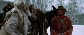 Movie still from “Jeremiah Johnson” (1972), directed by Sydney Pollack – A man standing in front of a group of animals; Medium shot, Low angle