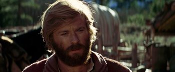 Movie still from “Jeremiah Johnson” (1972), directed by Sydney Pollack – A person with long hair and a beard; Close Up shot, Low angle