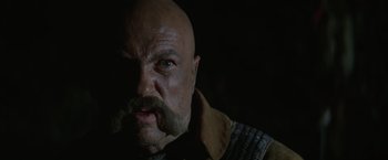 Movie still from “Jeremiah Johnson” (1972), directed by Sydney Pollack – A bald man with a beard and a mustache; Close Up shot, Low angle