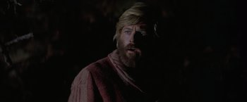 Movie still from “Jeremiah Johnson” (1972), directed by Sydney Pollack – A man with long hair and a beard wearing a red robe; Close Up shot, Low angle