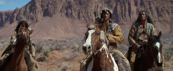 Movie still from “Jeremiah Johnson” (1972), directed by Sydney Pollack – A man riding on the back of a brown horse; Wide shot, Low angle