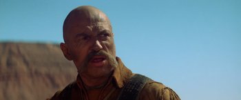 Movie still from “Jeremiah Johnson” (1972), directed by Sydney Pollack – A bald man with a mustache and a beard; Close Up shot, Low angle