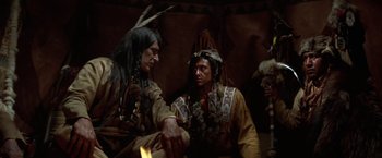 Movie still from “Jeremiah Johnson” (1972), directed by Sydney Pollack – Two native american men sitting in a tent; Medium shot, Low angle