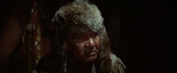 Movie still from “Jeremiah Johnson” (1972), directed by Sydney Pollack – An older man wearing a fur hat and a fur coat; Close Up shot, Low angle