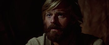 Movie still from “Jeremiah Johnson” (1972), directed by Sydney Pollack – A person with long hair and a beard; Close Up shot, Low angle