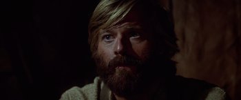 Movie still from “Jeremiah Johnson” (1972), directed by Sydney Pollack – A person with long hair and a beard; Close Up shot, Low angle