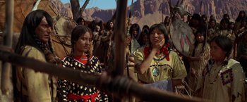 Movie still from “Jeremiah Johnson” (1972), directed by Sydney Pollack – A group of native american women standing next to each other; Medium shot, Over the shoulder angle