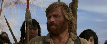 Movie still from “Jeremiah Johnson” (1972), directed by Sydney Pollack – A person with long hair and a beard; Close Up shot, Low angle